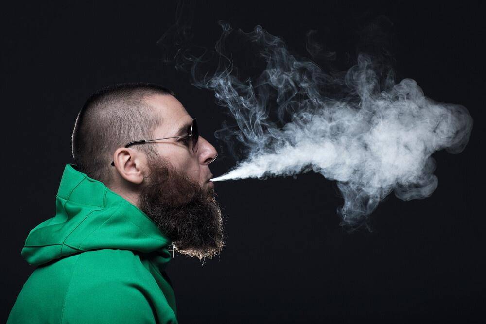 Man blowing out smoke