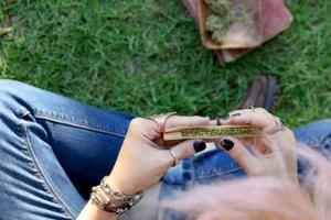 Rolling joint sitting on grass
