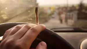 Guy hotboxing a car